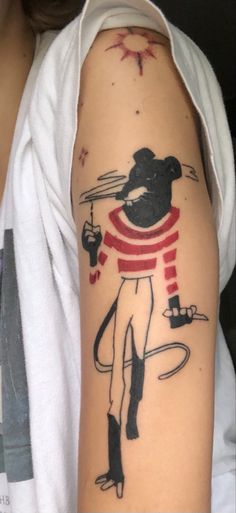 a person with a mouse tattoo on their arm