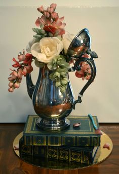 a vase with flowers on top of a book