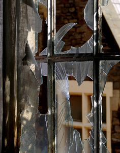 broken glass in front of a brick building