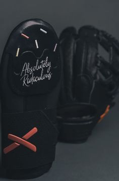 two black baseball gloves sitting next to each other