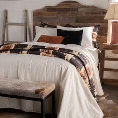 a bed with a wooden headboard and foot board