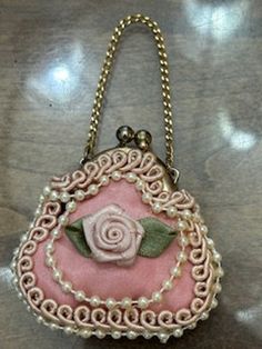 Very nice vintage Pink Rose small jeweled and silk lined ring/jewelry purse. Clasp snap small jewelry purse. Measure 2'' tall by 2 and 1/2'' wide. Pink rose with lace and pearl trim. Would be a very nice purse for a ring bearer to carry at wedding events.  Nice addition to the vintage and antique jewelry collection, vintage small jewelry purse collection, Weddings, valuable large coin or 2,  etc Thanks for viewing this very cute small jewelry purse and my shop. This small decorative ring purse w Purse Collection, Clasp Purse, Best Purses, Purse Vintage, Jewelry Clasps, Rose Ring, Vintage Purse, Ring Bearer, Small Jewelry