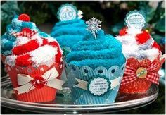 three cupcakes decorated with red, white and blue frosting on a cake plate