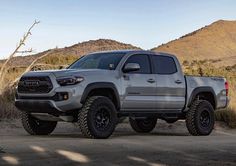 a silver toyota truck parked in the desert