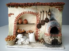 a clay oven with pots, pans and other items on it's shelves