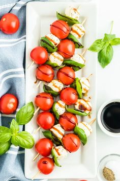 tomatoes and mozzarella on skewers with basil