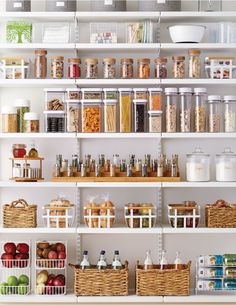 an organized pantry filled with lots of food and condiments, including apples, oranges, cereals, oatmeal