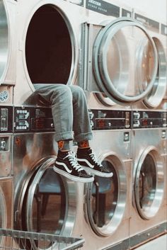 a person sitting on top of a stack of washers