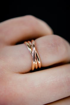 A bold, layered ring. This beautiful wrapped ring will become a staple in your wardrobe. This ring is handcrafted out of a D-shaped (half round) wire that is wrapped multiple times to create the appearance of three stacked rings. This listing is for ONE SINGLE ring in 14K ROSE GOLD FILL. Made from Extra Thick 2mm metal. SIZING NOTE: Because this style is wider than a classic Stacking Ring, we recommend sizing up* by a QUARTER to a HALF size from your US Fashion Ring Size (Bridal size is differen Overlap Ring, Gold Finger Rings, Stacked Rings, Interlocking Ring, Layered Rings, Us Fashion, Flat Back Earrings, Bold Rings, Single Ring