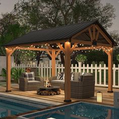 an outdoor living area next to a swimming pool with furniture and lights on the patio