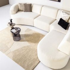 a white couch sitting on top of a rug in a living room