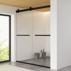 an empty room with sliding glass doors on the wall and tiled floor in front of it