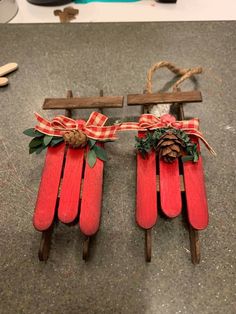 two wooden sleds with christmas decorations tied to them