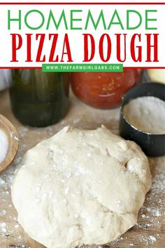 homemade pizza dough sitting on top of a wooden table