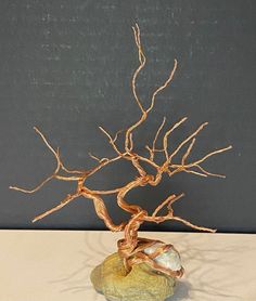 Small reclaimed copper wire tree atop a lucky sandstone rock with natural stone hole, with quartz wire in roots. Sculptures Sur Fil, White Tree Of Gondor, Tree Of Life Art, Wire Tree Sculpture, Bronze Art, Wire Trees, Tree Artwork, Metal Tree Wall Art, Wire Tree