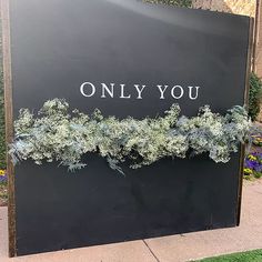 a sign that says only you on it with plants growing out of the top and bottom