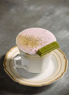 a cup filled with liquid sitting on top of a saucer