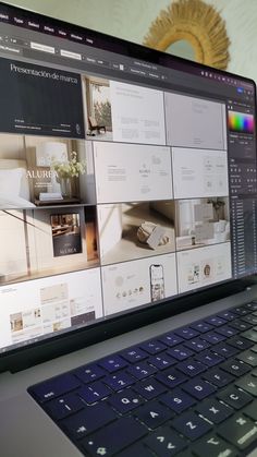 an open laptop computer sitting on top of a white desk next to a wall mounted tv