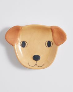 a ceramic dog head on a white wall