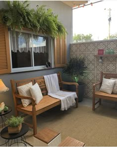 two wooden benches sitting next to each other on a patio