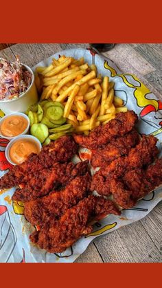 fried chicken, french fries and coleslaw are on a plate with pickles