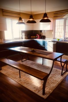 a wooden table sitting in the middle of a kitchen