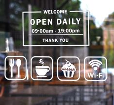 an open daily sign is posted on the glass door of a restaurant with various food and drink icons