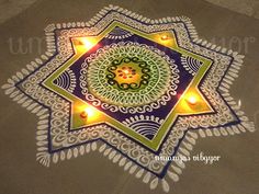 an intricate design with candles on the ground