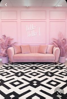 a living room with pink walls, black and white rugs and two couches