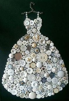 a dress made out of buttons on a black background with the words button art written below it