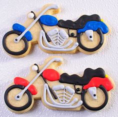 two cookies shaped like motorcycles on a white surface