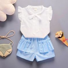 2-piece Ruffle Short Sleeve Shirt & Shorts for Toddler Girl - PrettyKid Light Blue Short Sleeve Sets For Summer, Light Blue Short Sleeve Summer Sets, Summer Ruffle Set With Shorts, Blue Short Sleeve Short Set For Spring, Cute Light Blue Sets For Playwear, Summer Ruffled Short Sets, Cute Blue Sets For Summer, Light Blue Cotton Sets For Summer, White Short Set For Playtime In Summer