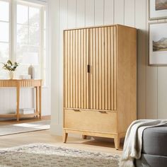 a living room with a couch and a wooden cabinet