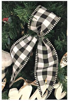 a black and white christmas ornament hanging from a tree