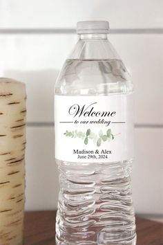 a bottle of water sitting on top of a wooden table