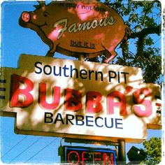 a sign for a restaurant with a pig on it's head and another sign that says southern pit bubba's barbecue