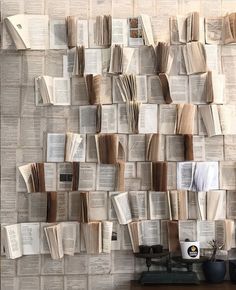 many books are stacked up on the wall