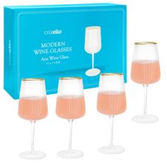 four wine glasses in front of a blue box