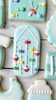 decorated cookies are arranged in the shape of birds and a birdcage on a table