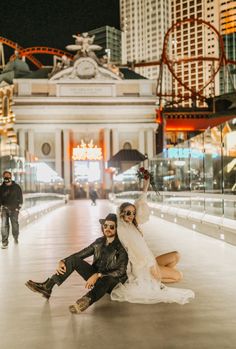 a bride and groom pose for a photo in front of the las vegas strip casino