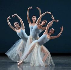 three ballerinas in tulle skirts are posing for the camera with their arms stretched out