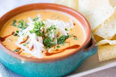 a bowl of soup with tortilla chips on the side