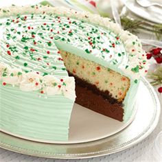 a cake with white frosting and green sprinkles