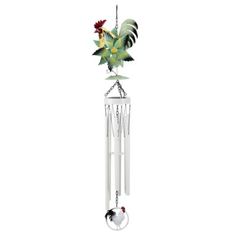 a white wind chime with green and red flowers