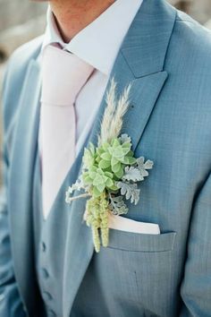 Grooms buttonhole natural succulents greenery, blue suit pink tie Blue Suit With Sage Green Tie, Blush Pink And Sage Green Wedding Men, Blue Suit Pink Tie Wedding, Blue Suit Pink Tie, Pastel Ties Groomsmen, Dusty Blue And Pink Boutonniere, Deep Blue Suit, Groom Blue Suit, Blue Tux