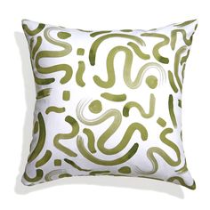 a green and white pillow with an abstract design on the front, sitting on a white surface