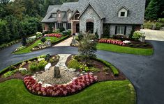 a large house with landscaping in the front yard and flowers around the entryway area