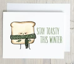 a card with a toast on it that says stay toasty this winter and has a green scarf around its neck