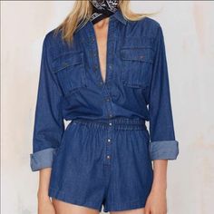 A Sleek Coating Brightens Up The Medium Blue Wash Of A Lightweight Denim Romper Featuring A Long-Sleeve, Button-Front Top Studded With Copper Snaps And Relaxed Shorts. 35 1/2" Length; 2 1/2" Inseam; 28.5” Leg Opening. Front Snap-Button Closure. Spread Collar. Two-Button Barrel Cuffs. 100% Cotton. Machine Wash Cold, Tumble Dry Low. Fits True To Size. Large = 10-12 High Waist Denim Tops For Fall, Fall High Waist Denim Tops, Casual Blue Button-up Denim Jumpsuit, Blue Casual Button-up Jumpsuits And Rompers, Long Sleeve Relaxed Fit Denim Jumpsuit With Button Closure, Casual Blue Button-up Jumpsuit, Denim Blue Button-up Jumpsuits And Rompers With Relaxed Fit, Blue Denim Long Sleeve Jumpsuits And Rompers, Denim Blue Button-up Relaxed Fit Jumpsuits And Rompers