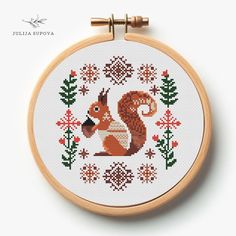 a cross stitch pattern with a squirrel on it